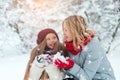 Attractive young girl with mother in winter time outdoor blowing snow Royalty Free Stock Photo