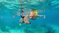 Mother, kid in snorkeling mask dive underwater with tropical fishes Royalty Free Stock Photo