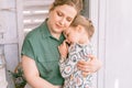 Happy family mother with little kid daughter girl have fun in suburb countryside home life on sunny day. candid mom holds child in Royalty Free Stock Photo