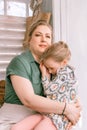 Happy family mother with little kid daughter girl have fun in suburb countryside home life on sunny day. candid mom holds child in Royalty Free Stock Photo