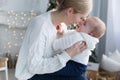 Happy mother with her young son on Christmas Eve near the Christmas tree Royalty Free Stock Photo