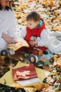 Happy family mother and little toddler baby daughter having fun together in autumn picnic Royalty Free Stock Photo