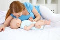 Happy family mother playing with baby in bed Royalty Free Stock Photo