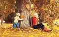 Happy family mother playing with child son in autumn park with yellow leaves Royalty Free Stock Photo
