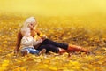 Happy family mother playing with child son in autumn park with yellow leaves Royalty Free Stock Photo