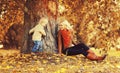 Happy family mother playing with child son in autumn park with yellow leaves Royalty Free Stock Photo