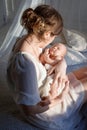 Happy family mother playing and hug with newborn baby in bed Royalty Free Stock Photo