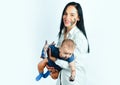 Happy family mother playing with newborn baby. Colorful painted hands in a beautiful young family. Pretty woman holding Royalty Free Stock Photo