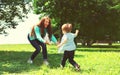 Happy family! Mother playing with son child having fun together on the grass in the park on a sunny summer day, life moment Royalty Free Stock Photo