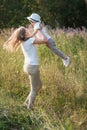 Happy family mother and son enjoying walk together at meadow in summer Royalty Free Stock Photo