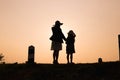 Happy family. A mother and son playing in grass fields outdoors at evening silhouette.Vintage Tone and copy space