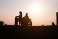 Happy family. A mother and son playing in grass fields outdoors at evening silhouette.Vintage Tone and copy space Royalty Free Stock Photo