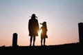 Happy family. A mother and son playing in grass fields outdoors at evening silhouette.Vintage Tone and copy space Royalty Free Stock Photo