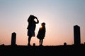 Happy family. A mother and son playing in grass fields outdoors at evening silhouette.Vintage Tone and copy space Royalty Free Stock Photo