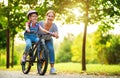 Happy family mother teaches child daughter to ride a bike in the Park Royalty Free Stock Photo