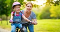 Happy family mother teaches child daughter to ride a bike in the Park Royalty Free Stock Photo