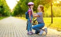 Happy family mother teaches child daughter to ride a bike in the Park Royalty Free Stock Photo