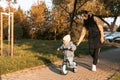 Happy family mother teaches child son to ride a bike in the Park. Crying boy fear, afraid idea. Family, childhood Royalty Free Stock Photo