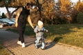 Happy family mother teaches child son to ride a bike in the Park. Crying boy fear, afraid idea. Family, childhood Royalty Free Stock Photo