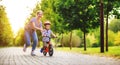 Happy family mother teaches child son to ride a bike in the Park Royalty Free Stock Photo