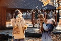 Happy family mother and teen boy son with cute cocker spaniel puppy blow soap bubbles outdoor in autumn park. Royalty Free Stock Photo