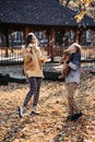 Happy family mother and teen boy son with cute cocker spaniel puppy blow soap bubbles outdoor in autumn park. Royalty Free Stock Photo