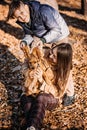 Happy family mother and teen boy son having fun with cocker spaniel puppy in autumn park Royalty Free Stock Photo