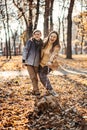 Happy family mother and teen boy son having fun with cocker spaniel puppy in autumn park Royalty Free Stock Photo