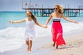 Happy family mother and teenager daughter run, laugh and play at beach Royalty Free Stock Photo