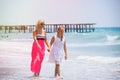 Happy family mother and teenager daughter walk, laugh and play at beach Royalty Free Stock Photo