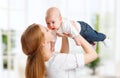 Happy family mother throws up child baby at home Royalty Free Stock Photo