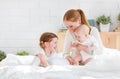 Happy family mother and two children, son and daughter in bed Royalty Free Stock Photo