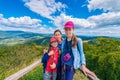 Happy family - mother and two daughters - on a hiking trip to the mountains Royalty Free Stock Photo