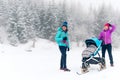 Happy family in mountains. Mother with baby stroller enjoying mo Royalty Free Stock Photo