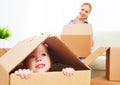 Happy family moves into a new apartment. happy baby in a cardboa Royalty Free Stock Photo