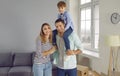 Happy family on moving day on a new home with their child son smiling and looking at camera. Royalty Free Stock Photo