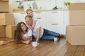 Happy family moving home with boxes around