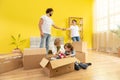 Happy family moving in a new home their kids are very excited they take a sit with all family on the sofa in the large Royalty Free Stock Photo