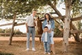 Happy family near horses at a farmer& x27;s ranch at sunset Royalty Free Stock Photo