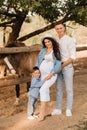 Happy family near horses at a farmer& x27;s ranch at sunset Royalty Free Stock Photo