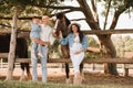 Happy family near horses at a farmer's ranch at sunset Royalty Free Stock Photo