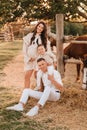 Happy family near horses at a farmer's ranch at sunset Royalty Free Stock Photo