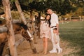 Happy family near horses at a farmer& x27;s ranch at sunset Royalty Free Stock Photo