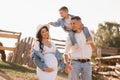 Happy family near horses at a farmer& x27;s ranch at sunset Royalty Free Stock Photo