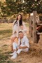 Happy family near horses at a farmer& x27;s ranch at sunset Royalty Free Stock Photo