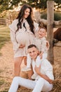 Happy family near horses at a farmer& x27;s ranch at sunset Royalty Free Stock Photo