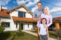 Happy family near new house. Real estate concept. Royalty Free Stock Photo