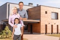 Happy family near new house. Real estate concept. Royalty Free Stock Photo