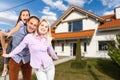 Happy family near new house. Real estate concept. Royalty Free Stock Photo