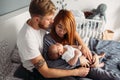 Happy family with newborn baby on the bed Royalty Free Stock Photo